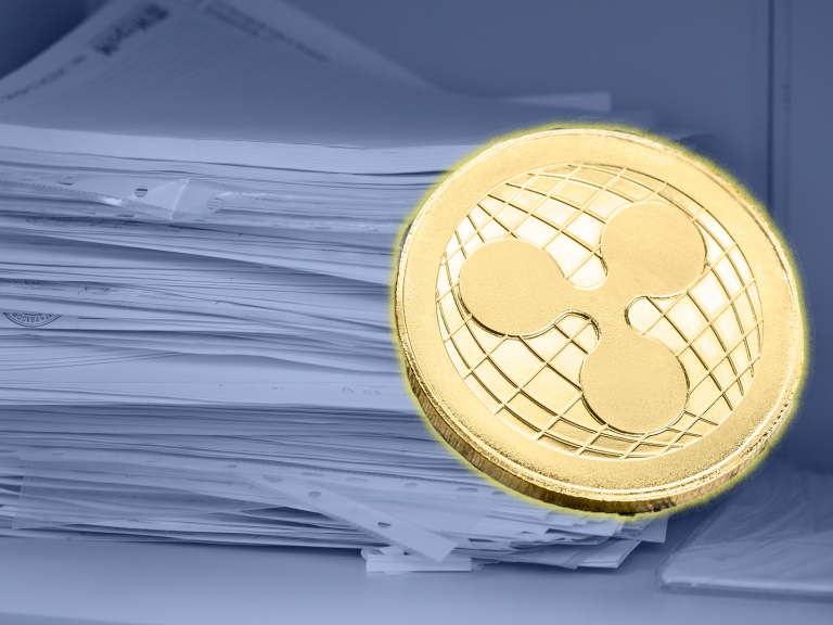 a pile of documents and XRP token